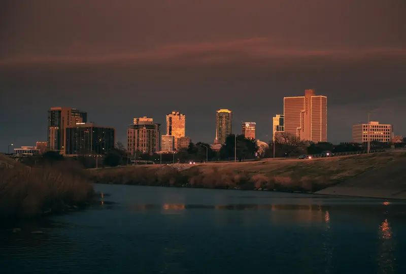 Fort Worth skyline at dusk above the Trinity River